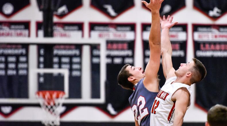 Carlisle’s Justin Flor (22) and Franklin’s Braden Hall go up on the tipoff at a Jan. 2 game at Franklin’s Darrell Hedric Gym. The host Wildcats won 88-47. NICK GRAHAM/STAFF
