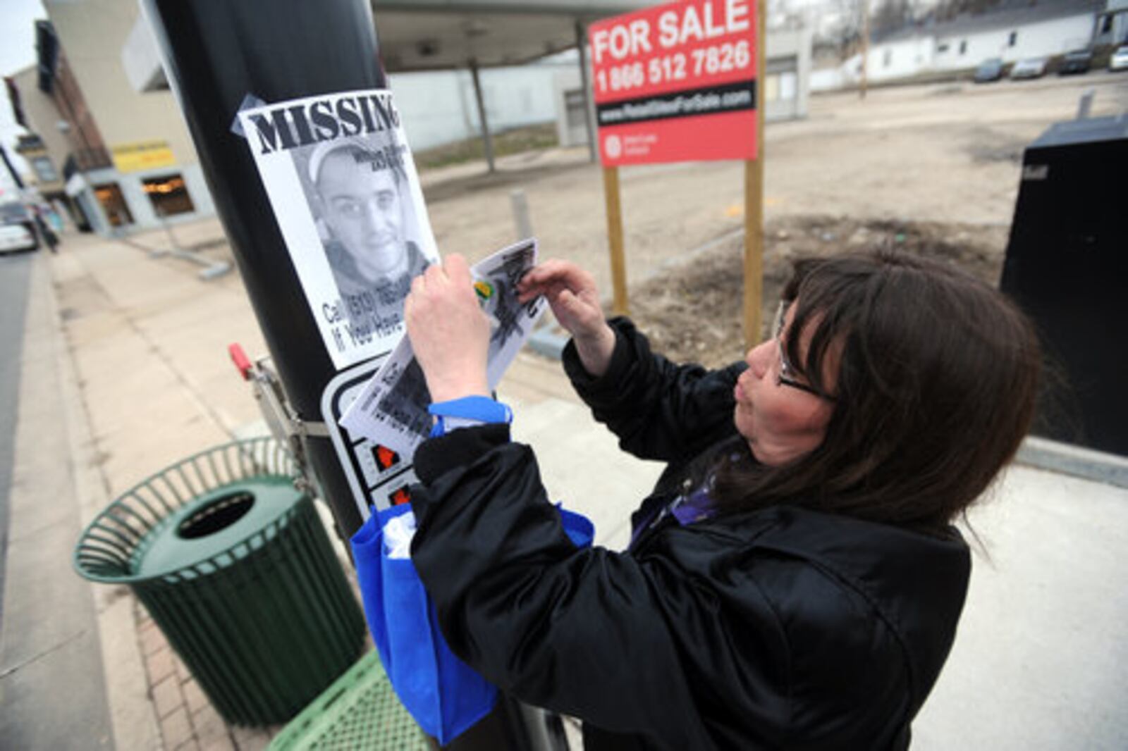 Debbie Estes papers the west side of Hamilton on Saturday, Feb. 26, 2011 with flyers of her son, William DiSilvestro, 28, who was reported missing Feb. 11. Known as Billy D., he suffers from epilepsy and was last seen on Ross Avenue. Over 100 people--friends, family and strangers--turned out to help her search. "I'm not a rich person but I feel rich today," she said, regarding the turnout to help her find her son.