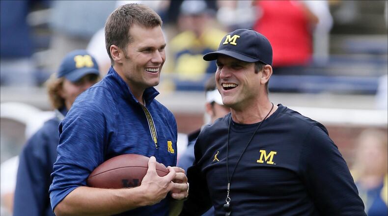 ANN ARBOR, MI - SEPTEMBER 17: Quarterback Tom Brady of the New England Patriots laughs with head coach Jim Harbaugh of the Michigan Wolverines after they played catch before a game against the Colorado Buffaloes at Michigan Stadium on September 17, 2016 in Ann Arbor, Michigan. (Photo by Duane Burleson/Getty Images)