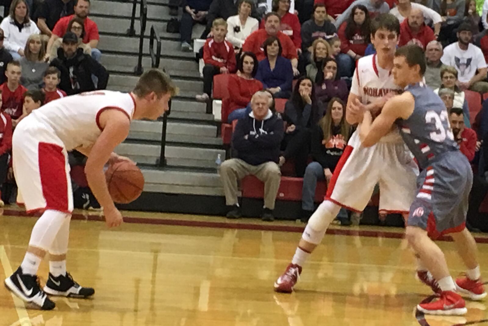 Madison’s Mason Whiteman prepares to run a play as teammate Grant Whisman is guarded by Carlisle’s Dane Flatter (33) during Tuesday night’s game in Madison Township. RICK CASSANO/STAFF