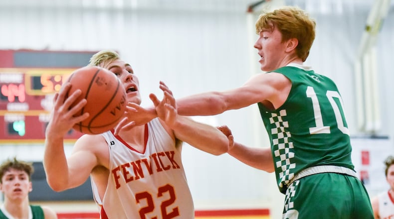 Fenwick’s C.J. Napier drives to the basket defended by Badin’s Zach Switzer during Friday night’s game in Middletown. Fenwick won 56-45. NICK GRAHAM/STAFF