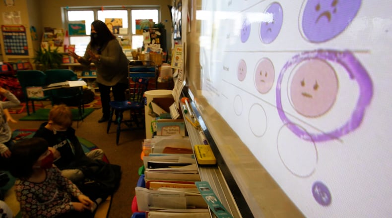File - Second-grade teacher Melissa Shugg teaches a lesson at Paw Paw Elementary School about thoughts, feelings and actions on Thursday, Dec. 2, 2021, in Paw Paw, Michigan. Shugg is one of many teachers at the school who've been trained to teach a social-emotional curriculum created at the University of Michigan called TRAILS. Research suggests TRAILS lessons for at-risk kids can reduce depression and improve coping skills. (AP Photo/Martha Irvine)