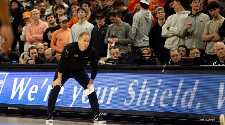 BYU head coach Kevin Young stands on the baseline in the first half of an NCAA college basketball game against Oklahoma State, Wednesday, Feb. 4, 2026 in Stillwater, Okla. (AP Photo/Mitch Alcala)