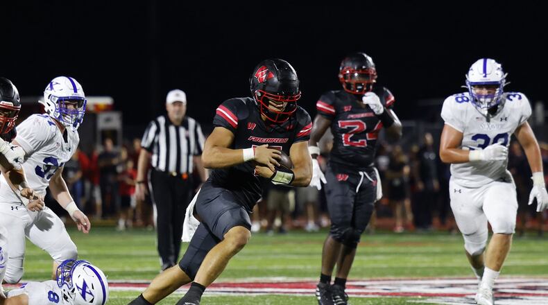 Lakota West quarterback Mitch Bolden carries the ball during their 16-13 win over St. Xavier Friday, Aug. 19, 2022 at Lakota West High School in West Chester Township. NICK GRAHAM/STAFF