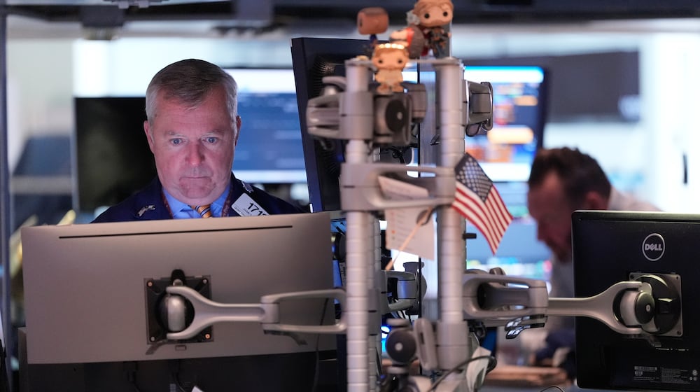 James Lamb works on the floor at the New York Stock Exchange in New York, Thursday, Nov. 13, 2025. (AP Photo/Seth Wenig)