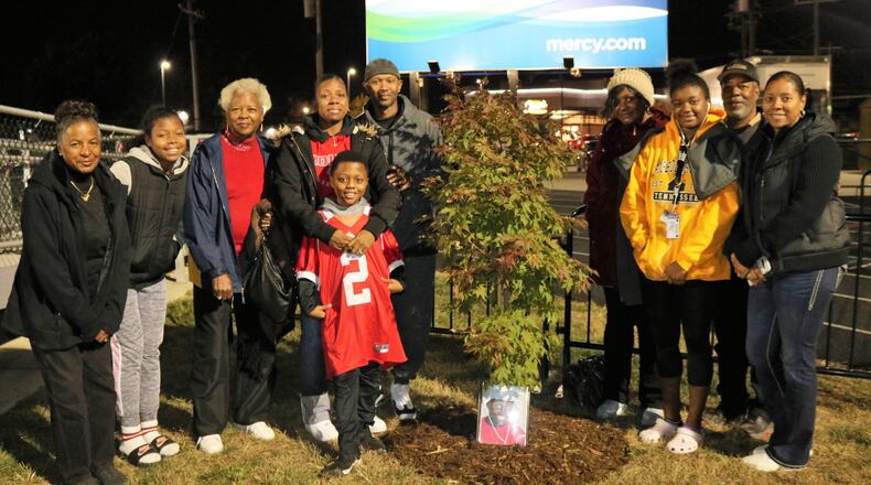Mason Blanchard’s family members gather at the tree during the dedication ceremony prior to the start of the Fairfield-Oak Hills football game on Oct. 25. PROVIDED