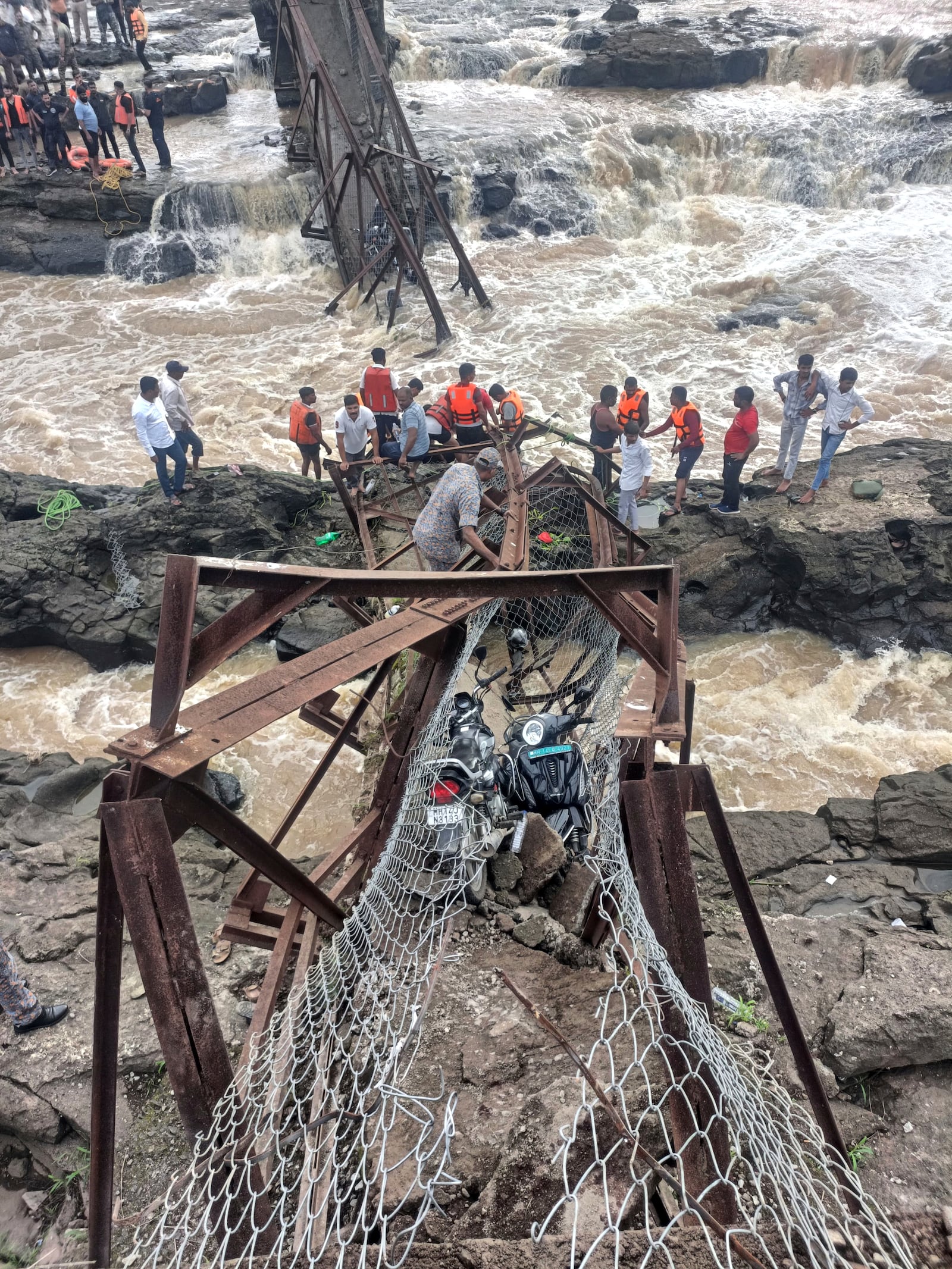 Rescuers work at the site of a bridge collapse near Pune, India, Sunday, June 15, 2025. (AP Photo)