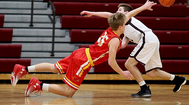 Fenwick forward Luke Bradshaw gets off a pass as Lebanon guard Sammy Stotts pressures during their game at Lebanon on Dec. 17, 2016. COX MEDIA FILE PHOTO