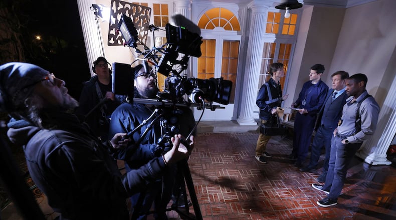 Left to right: Director of Photography Phillip Booth operates the camera and Adam Michael Johnson pulls focus during a scene with actors Mark Schuliger, Greg Lehman, Michael Paré and Wendell Kinney on set of director Lana Read's new film, "Death for Dinner", at the historic home of Helen and Rick Stevens-Gleason in early morning hours Saturday, March 16, 2024 in Middletown. NICK GRAHAM/STAFF