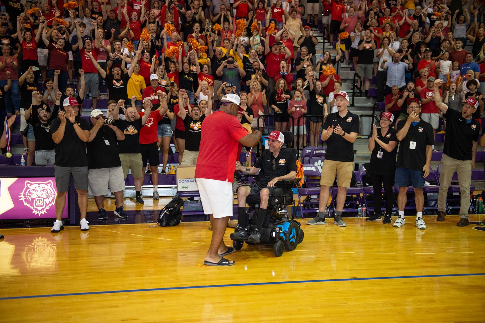 Pete Ehrlich, who was diagnosed with ALS two years ago, coached the Fenwick high School boys volleyball team to its first state title since 2013. He receives his state championship medal and a standing ovation from the crowd. PHOTO BY JTH PHOTOGRAPHY