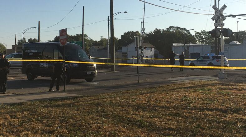 Middletown police investigate a person who was found lying on the railroad tracks at University Boulevard and Manchester Avenue Tuesday morning. The Butler County Coroner’s Office responded to the scene. RICK McCRABB/STAFF