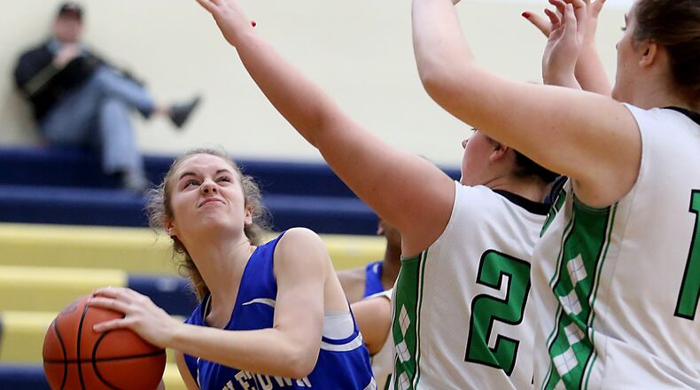 Middletown Christian’s Anna Crawford shoots while being covered by Fayetteville’s Haley Moore (21) and Margo Thompson (15) during their Division IV sectional game at Monroe on Feb. 21, 2017. COX MEDIA FILE PHOTO
