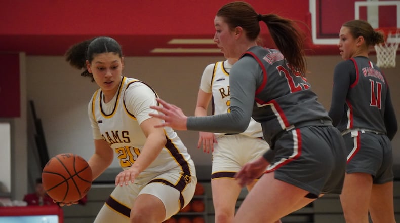 Ross senior Kelis Egodotaye dribbles the ball into the lane against Goshen in a Division III district semifinal on Tuesday night at Princeton. CHRIS VOGT / CONTRIBUTED