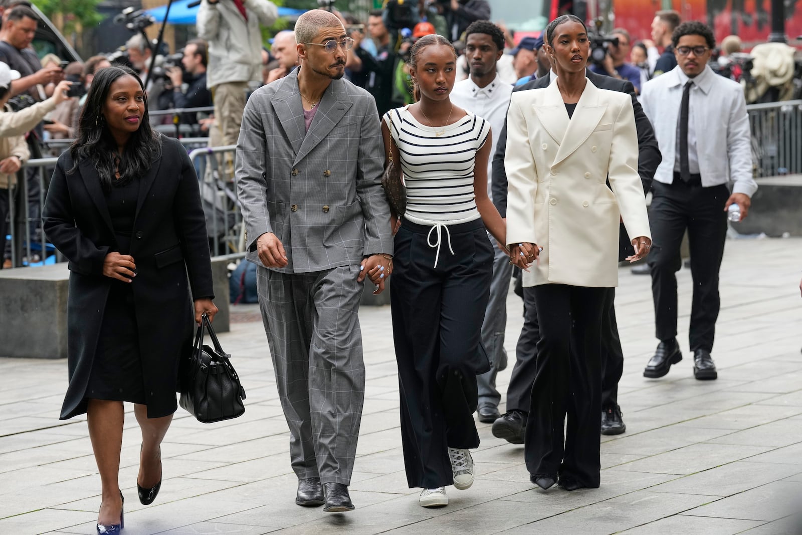 Quincy Combs, second from left, and Chance Combs center, arrive at Manhattan federal court, Tuesday, May 13, 2025, in New York. (AP Photo/Seth Wenig)