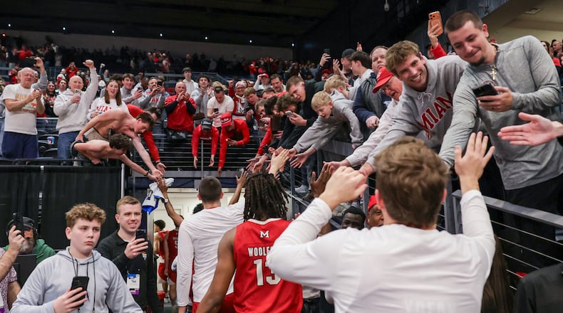 Miami fans cheer and clap hands with players following an 89-79 win over Southern Methodist in an NCAA First Four game on Wednesday, March 18 at University of Dayton Arena. BRYANT BILLING / STAFF