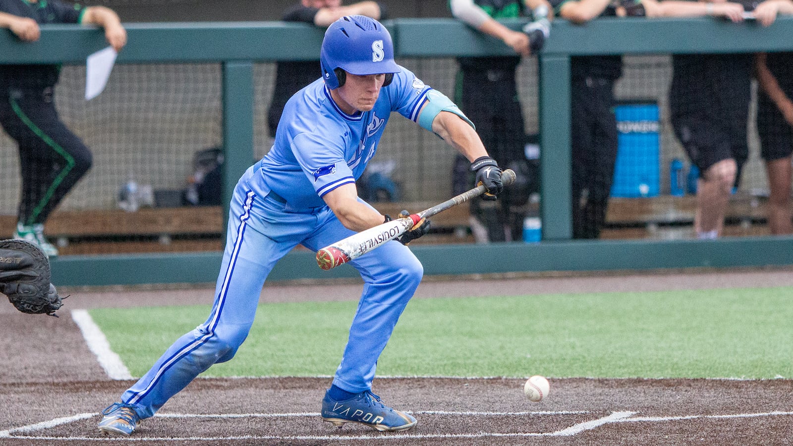 Springboro's Vince Fortkamp bunts for a single that scored Adam Smith for a 2-1 lead in the fourth inning in Thursday's Division I regional final. Jeff Gilbert/CONTRIBUTED