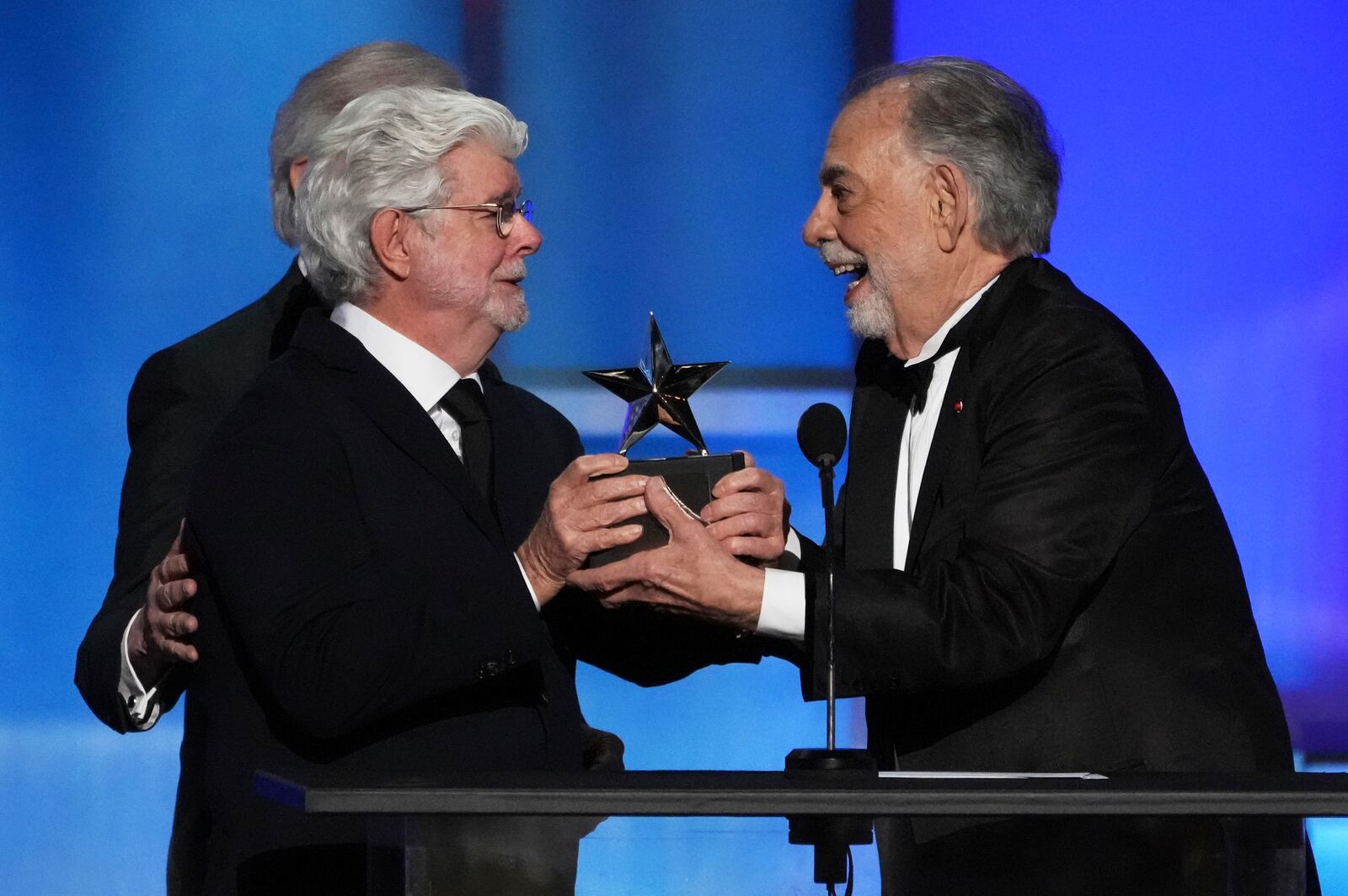 Filmmaker Francis Ford Coppola, right, accepts the 50th AFI Life Achievement Award from presenter George Lucas during a gala tribute to Coppola on Saturday, April 26, 2025, at the Dolby Theatre in Los Angeles. (AP Photo/Chris Pizzello)
