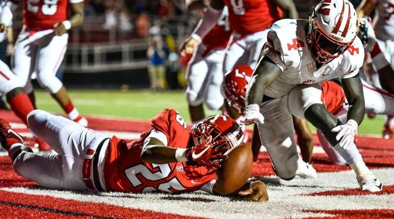 Lakota West’s David Afari (4) and Fairfield’s Corey Smith battle for a fumbled ball during a Sept. 14 game at Fairfield Stadium. The host Indians won 37-3. NICK GRAHAM/STAFF