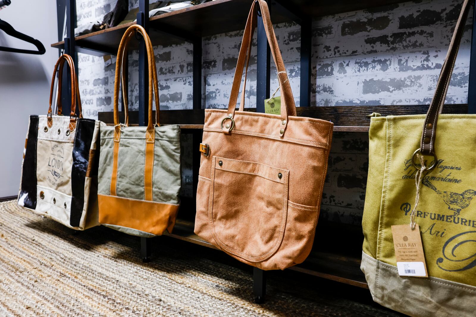 Bourbon and Fire will open their new storefront Wednesday, June 28 on Main Street in Hamilton. The store features custom laser engraved bourbon barrel lid games and decor, mixers, cigars and more. The back of the shop has a curated clothing boutique. NICK GRAHAM/STAFF