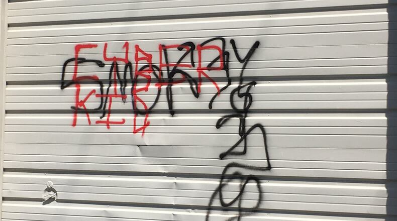 Vandals painted a garage door used by the Middletown Lyric Theater at its building on Central Avenue. RICK McCRABB/STAFF