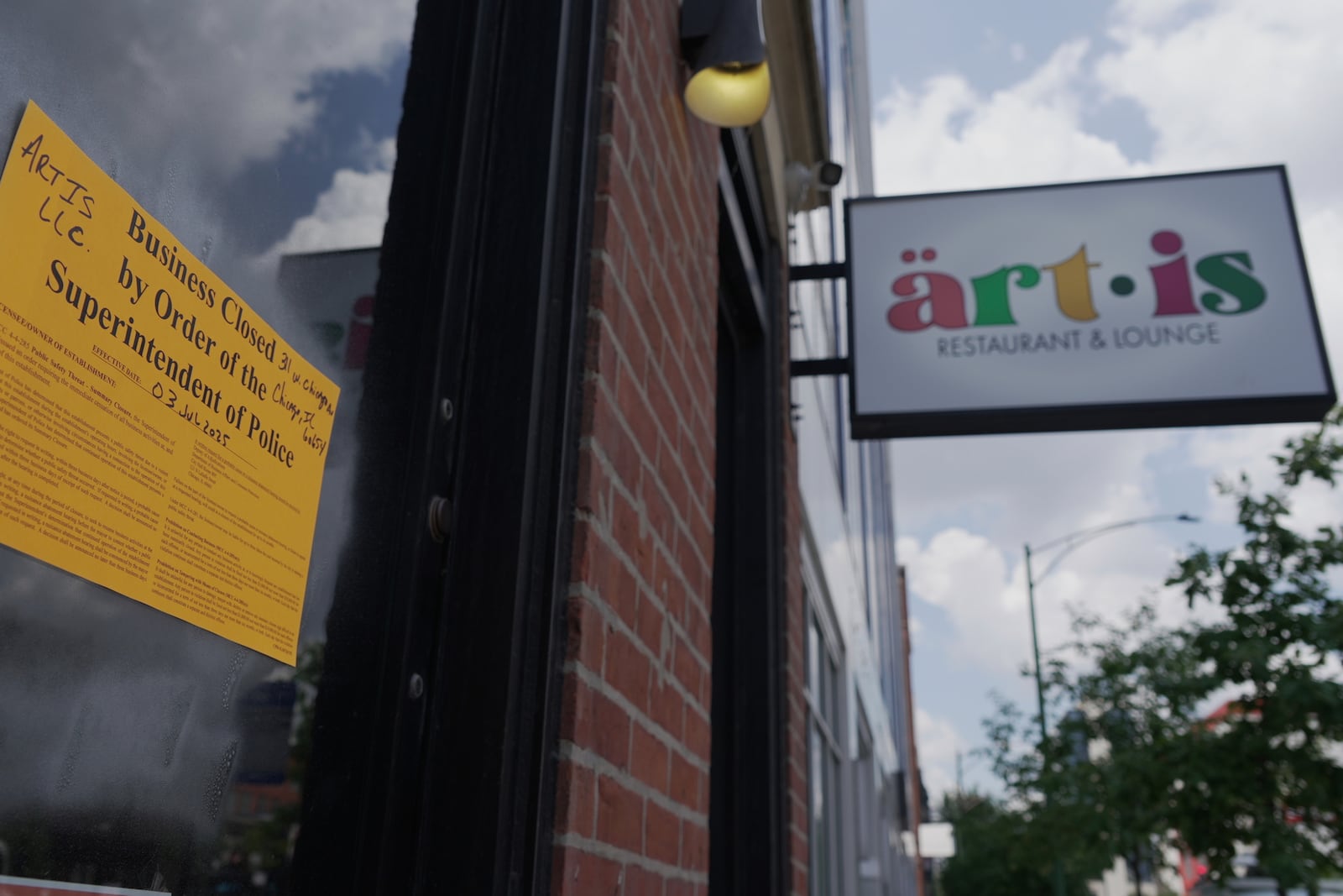 A sign shows Artis Restaurant and Lounge in Chicago has been closed by police on Thursday, July 3, 2025 following a deadly shooting the previous night. (AP Photo/Laura Bargfeld)