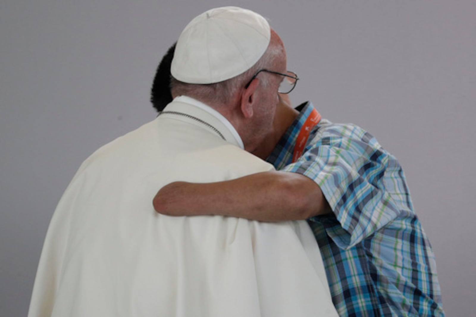FILE - Former FARC rebel Carlos Juan Carlos Murcia, who lost his left hand, embraces Pope Francis during a prayer meeting for reconciliation at Las Malocas Park in Villavicencio, Colombia, Friday, Sept. 8, 2017. (AP Photo/Andrew Medichini, file)