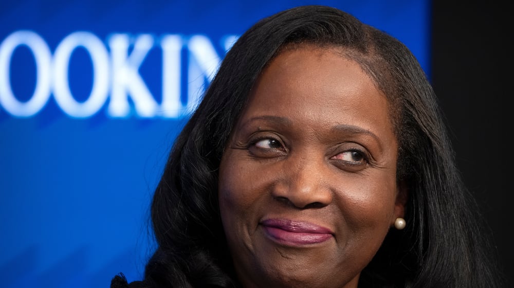 FILE - Lisa Cook, a Federal Reserve Board of Governors member, reacts during an event at the Brookings Institution, Monday, Nov. 3, 2025, in Washington. (AP Photo/Mark Schiefelbein, File)