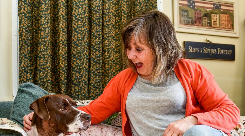 Wanda Chapman with her dog Cocoa Bean has suggested to Hamilton city council to create an ordinance that restricts the way Hamilton residents can tether their dogs out of concern for the animals. NICK GRAHAM/STAFF