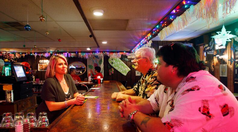 ARCHIVED PHOTO from 2011:  Bartender Dawn Booher, left, talks with co-owners Larry Parr, middle, and Eddie Holbrook, right, inside of  the Paradise Key Cafe  on Needmore Road in Dayton.