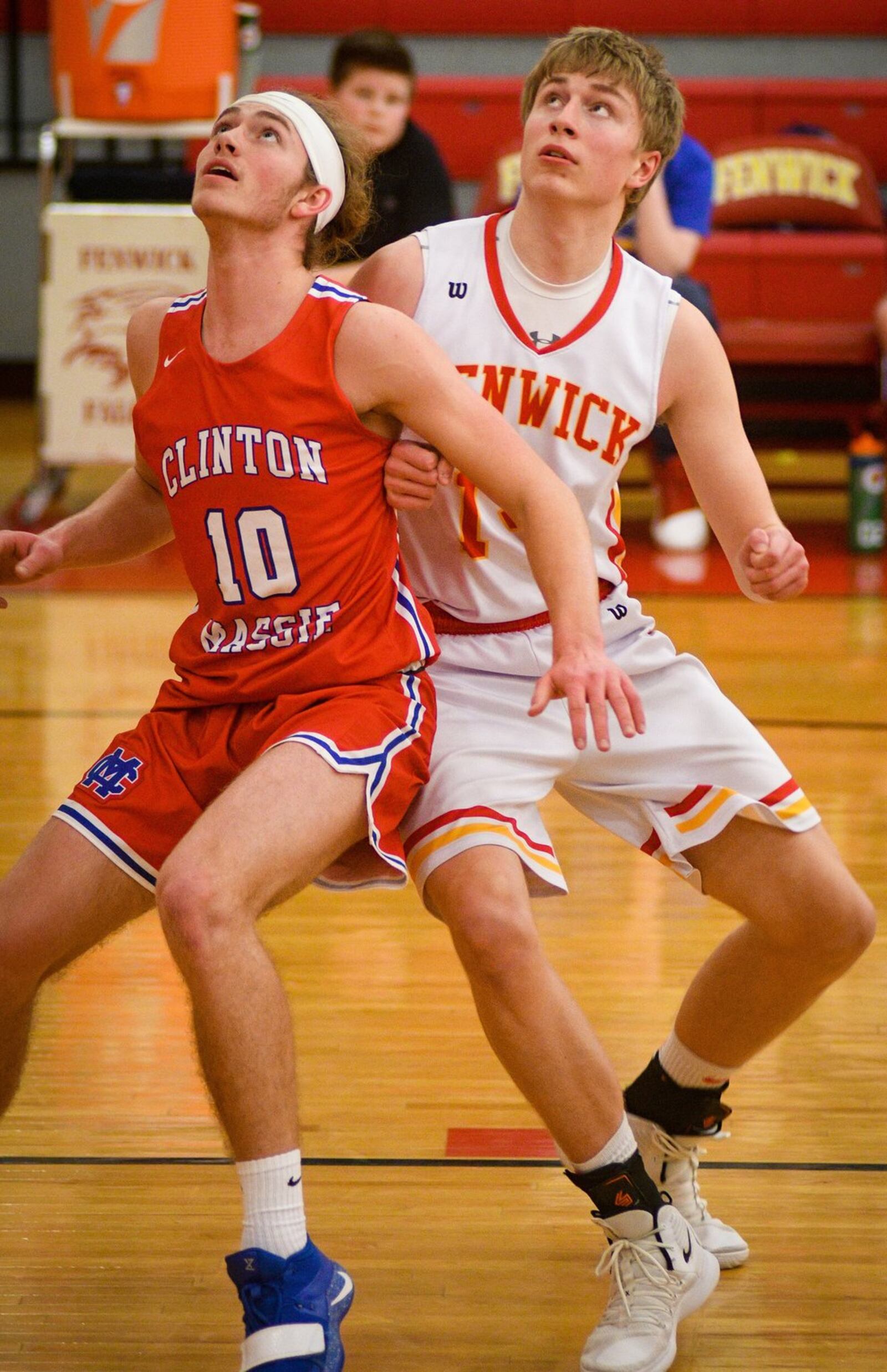 Clinton-Massie’s Tate Olberding (10) and Fenwick’s Michael Boon prepare to go after a rebound during Monday night’s game at Fenwick. The host Falcons won 67-48. ROB MCCULLEY/RAM PHOTOGRAPHY