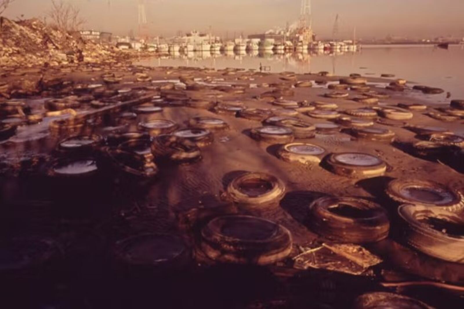 Discarded tires litter the shorefront of Baltimore Harbor in 1973. Jim Pickerell, Documerica Project, U.S. National Archives