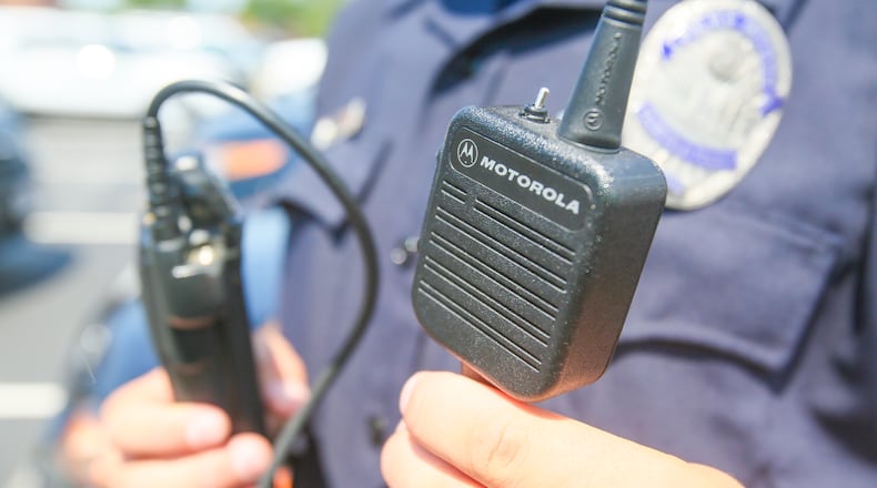 Fairfield Police officer Scott Webb displays his radio outside the police station, Wednesday, Aug. 2, 2017. Butler County officials and police and fire departments across the county are looking at a $19.2 million price tag to replace parts of the 800 MHz communications systems, including the radios first responders carry.GREG LYNCH / STAFF