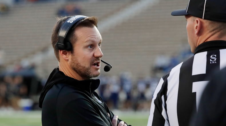 Memphis head coach Ryan Silverfield, left, talks with an official after a penalty during the first half of an NCAA college football game against Rice, Friday, Oct. 31, 2025, in Houston. (AP Photo/Michael Wyke)