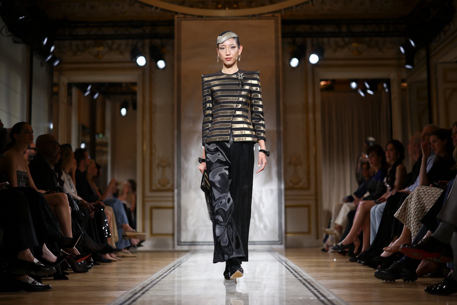 A model wears a creation as part of the Giorgio Armani Prive Fall-Winter 2025/26 Haute Couture collection presented Tuesday, July 8, 2025, in Paris. (AP Photo/Tom Nicholson)