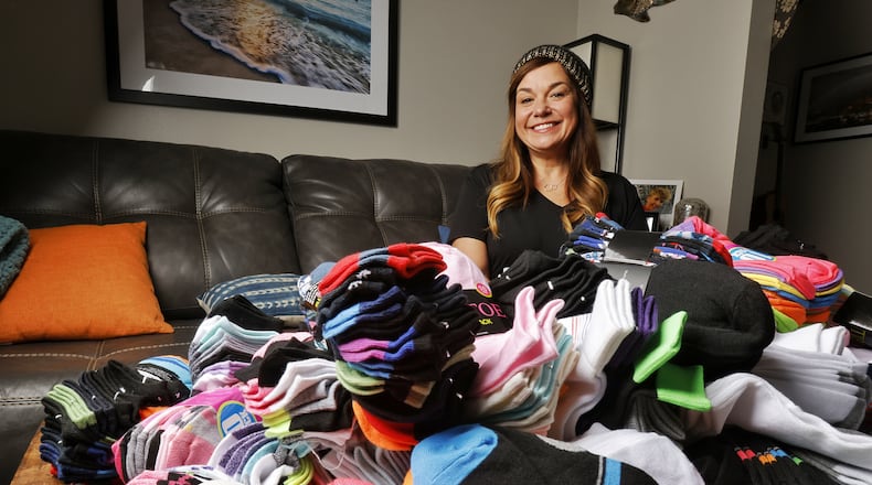 Monique Runzer collected socks and other items for her Socks for Hamilton Youth program. This was her third year of gathering socks to give to local youth in need through the Caring Closet. NICK GRAHAM / STAFF