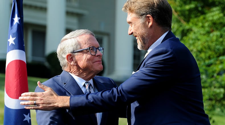 Ohio Gov. Mike DeWine, left, shakes hands with Joby Aviation Inc. founder JoeBen Bevirt at Hawthorn Hill, the home of Orville Wright in Oakwood, to announce Monday, Sept. 18, 2023, his company's pledge to bring thousands of jobs to the region at through a facility near Dayton International Airport that specializes in the production of "flying cars." MARSHALL GORBY\STAFF