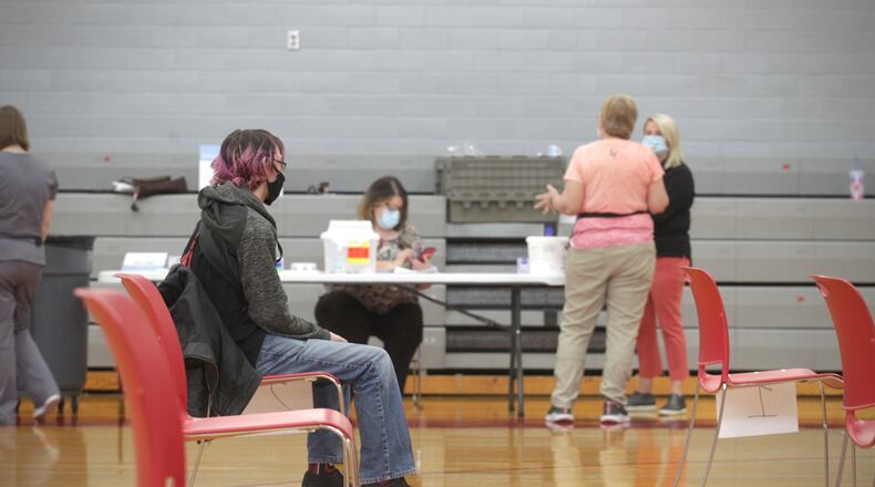 Stebbins High School sophomore, Ryan Riesenbeck waits for 15 minutes after he received a COVID-19 vaccination at the school Wednesday April 28, 2021. JIM NOELKER/STAFF