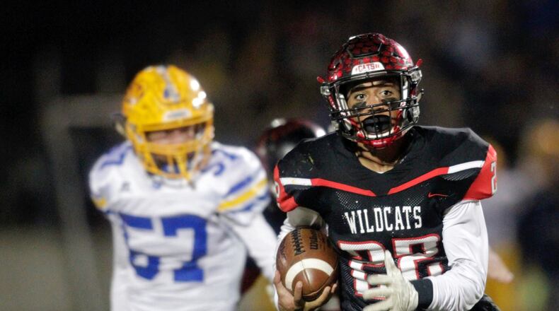 Franklin’s Ryan Montgomery gets past Jackson Harris (57) of St. Marys Memorial during a Division III, Region 12 semifinal Nov. 12, 2016, at Wayne’s Heidkamp Stadium. The season came to an end for Montgomery’s Wildcats by a 55-31 score. NICK GRAHAM/STAFF