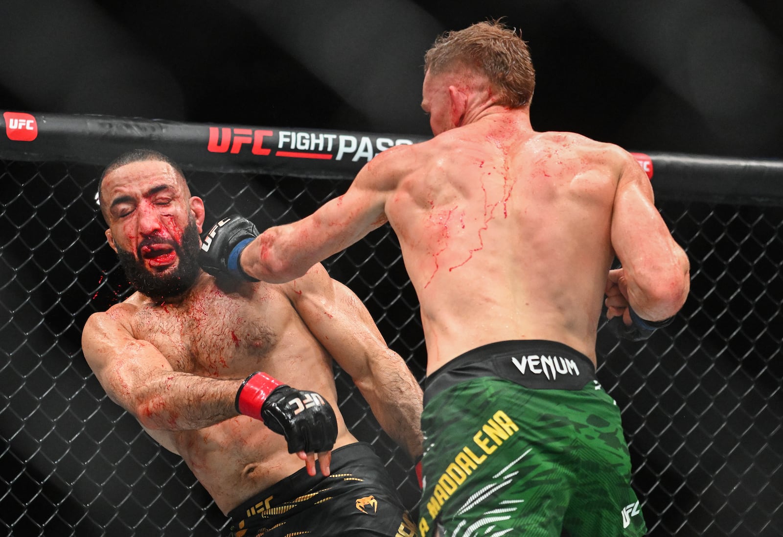 Belal Muhammad, left, takes a blow from Jack Della Maddalena during their UFC 315 mixed martial arts welterweight title bout in Montreal, Sunday, May 11, 2025. (Graham Hughes/The Canadian Press via AP)