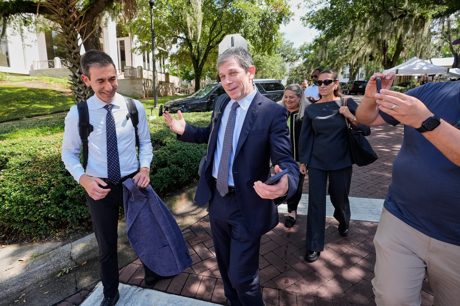David Oscar Markus, attorney for Ghislaine Maxwell, center, is questioned by the media outside the federal courthouse in Tallahassee, Fla., Thursday, July 24, 2025. (AP Photo/John Raoux)