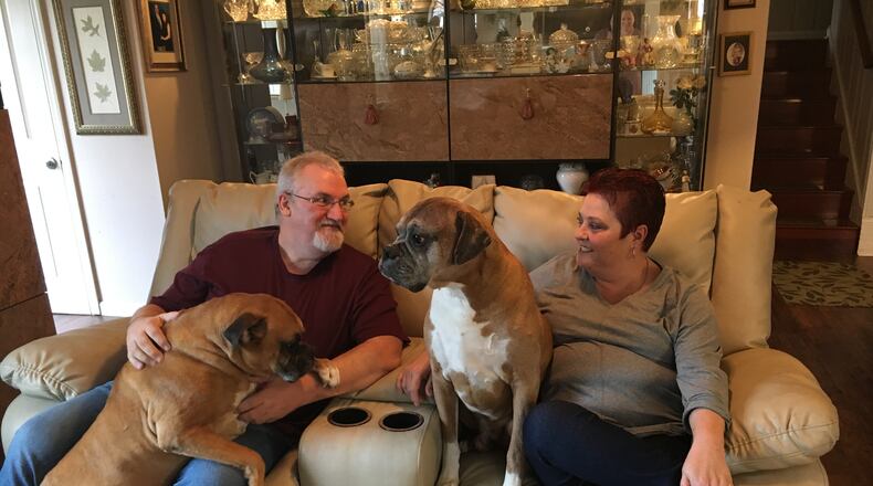 Don and Lisa Gose, of Middletown, sit with two of their three dogs, Zorro and Max. The Gose’s worry how they will continue to pay for Lisa’s medication, one of the most expensive specialty drugs in the world, in the future. KATIE WEDELL/STAFF
