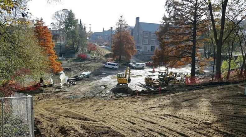 Construction crews have removed the concrete sides and brick bottom of Mirror Lake on the Ohio State University campus. Workers are installing new utilities, and the renovation is expected to be completed in spring. KYLE ROBERTSON/THE COLUMBUS DISPATCH