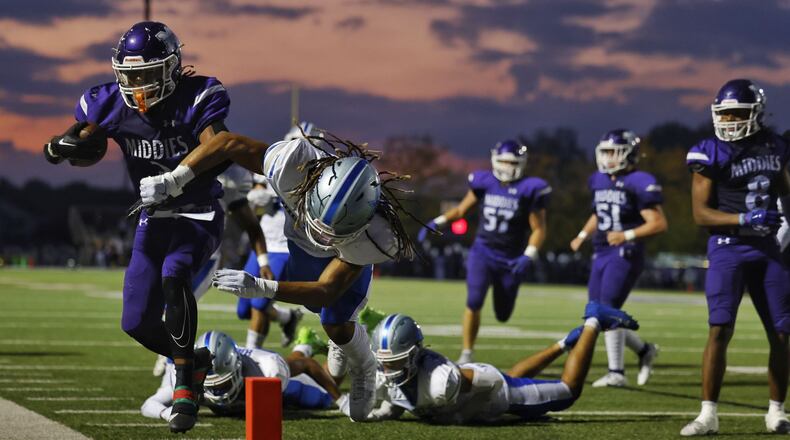 Middletown's Eric Schroeder gets knocked out of bounds by Hamilton's Jailen Morris  during their football game Friday, Sept. 29, 2013 at Middletown's Chris Carter Field at Barnitz Stadium. Hamilton won 18-14. NICK GRAHAM/STAFF