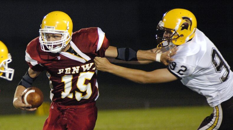 Fenwick quarterback Joe Murphy avoids a tackle attempt by Roger Bacon’s Luke Sunderman during a game at Krusling Field on Aug. 26, 2005. NICK GRAHAM/STAFF