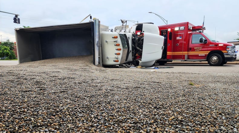 A dump truck hauling gravel ended up on its side spilling gravel on Reinartz Blvd. Friday morning in Middletown. The crash closed the intersection of Reinartz Blvd. and Verity Pkwy. The truck driver was transported from the scene by ambulance. NICK GRAHAM/STAFF