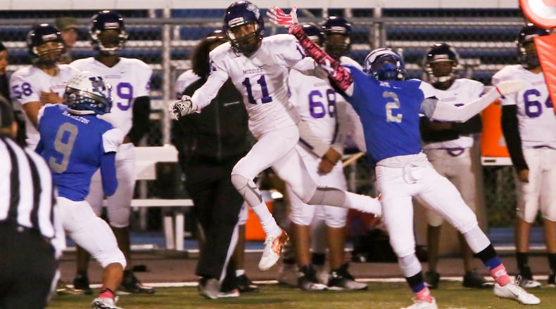 Middletown wide receiver Will Thomas (11) goes up against Hamilton’s Domonick Johnson (2) during a game Oct. 21, 2016, at Virgil Schwarm Stadium in Hamilton. Host Big Blue won 34-10. GREG LYNCH/STAFF