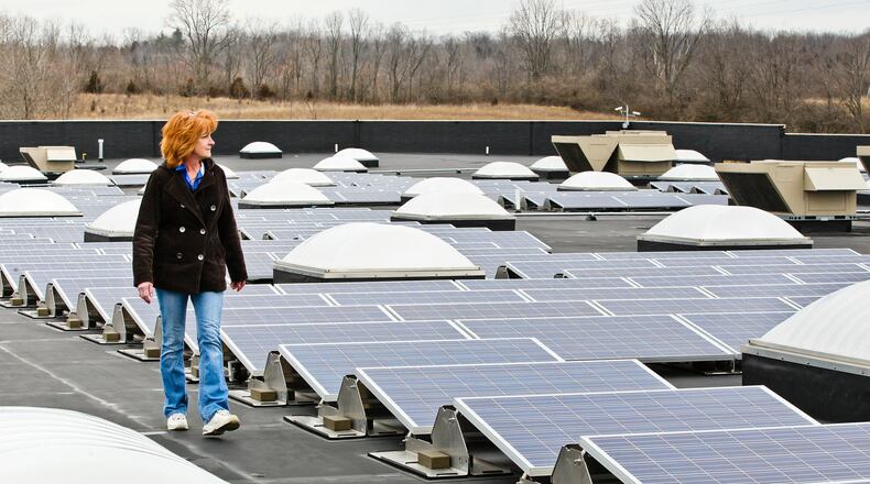 Walmart assistant manager Vicki Meredith walks past solar power arrays installed atop the Franklin location. NICK DAGGY / STAFF