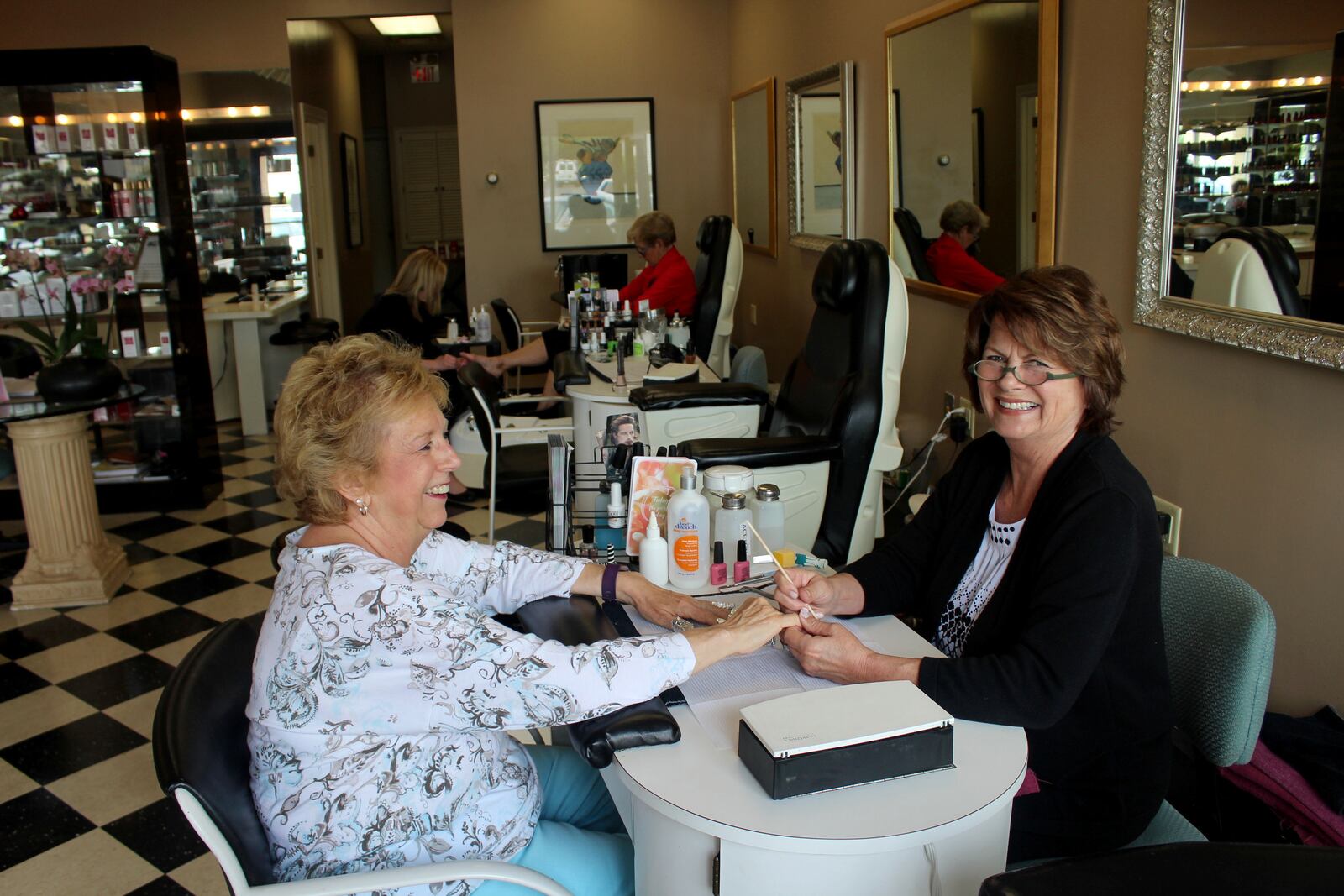 Martha's Skin Care is closing after its lease was not renewed.  Cindy Gray a Martha’s nail technician 24 years,  said the loss of lease has prompted her to retire. She is pictured with her client Charlene Sims