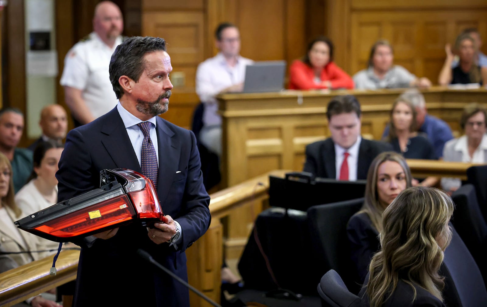 Defense attorney Alan Jackson questions accident reconstruction specialist Dr. Daniel Wolfe while holding a 2021 Lexus SUV taillight assembly during Karen Read's murder trial in Norfolk Superior Court in Dedham, Mass., Friday, June 6, 2025.(Mark Stockwell/The Sun Chronicle via AP, Pool)