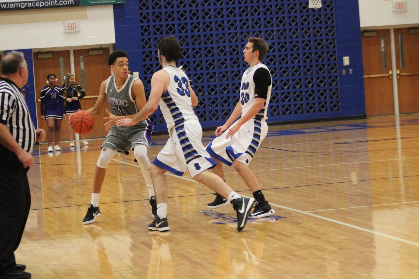 Middletown’s Cliff Snow (11) is guarded by Thomas Arrington (33) and Trey Varinsky (30) of Springboro during Saturday night’s game at SHS. CONTRIBUTED PHOTO BY MARITZA MCKINNEY
